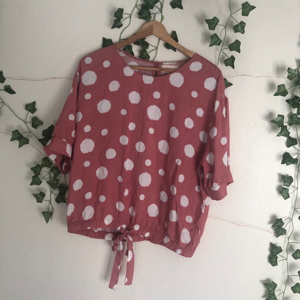 pink shirt with white polka dots